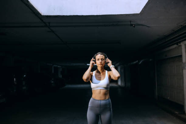 istock Young athlete woman getting ready for running in underground garage 1635814868