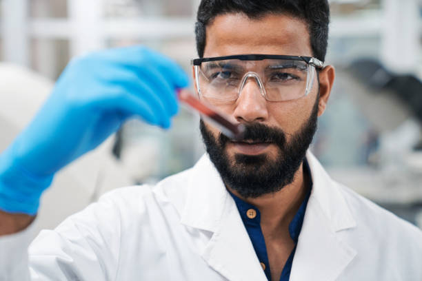 istock Focused male scientist examining sample in laboratory 1635831341