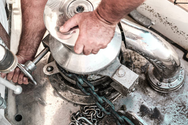 istock sailor man hands fixing hydraulic operated anchor windlass 1635835229