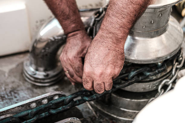 istock sailor man hands fixing hydraulic operated anchor windlass 1635835241