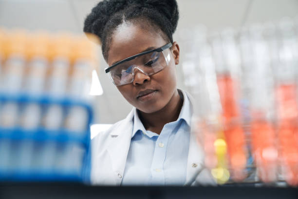 istock Low angle view of young female scientist wearing protective eyeglasses at laboratory 1635835766