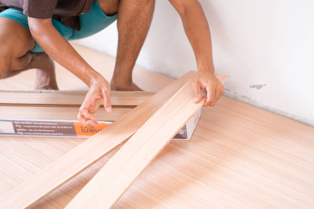 istock Mechanical man setting laminate floor in new house interior building work 1635841542