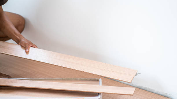 istock Mechanical man setting laminate floor in new house interior building work 1635841543