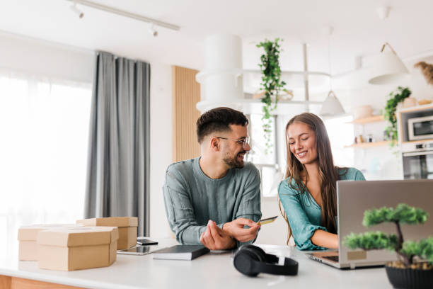 istock Young couple shopping online at home 1635844488