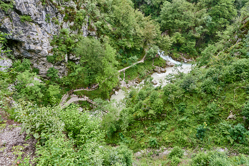 Tourists visiting the Tolmin Gorge, locally known as Tolminka and Zadlaica Gorges, a popular tourist destinaton in the Triglav National Park. Tolmin Municipality. Gorizia Region. Slovenia.