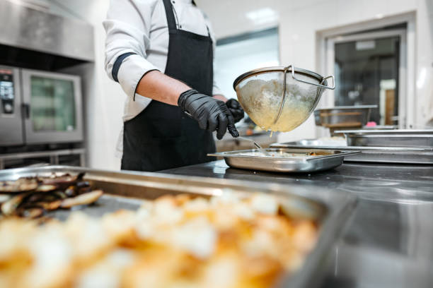 istock Chef cooking food at restaurant kitchen close up 1635870894