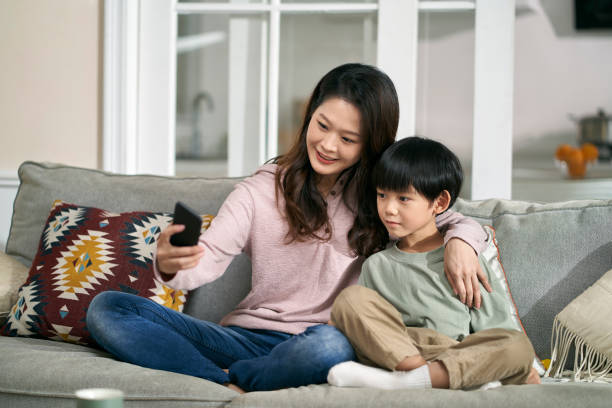 istock asian mother and son taking a selfie together at home using cellphone 1635912827