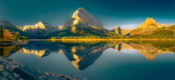 istock Panoramic Reflections of Swift Current Lake in Glacier National Park 1635916974