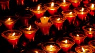 istock Lots of burning candles in glass candlesticks in the dark. 1635931765