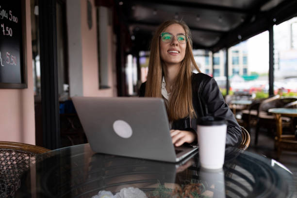 istock young female freelancer working on a laptop remotely in a cafe 1635947848