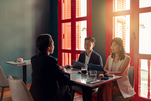 Senior managers interview a new applicant at a dining venue