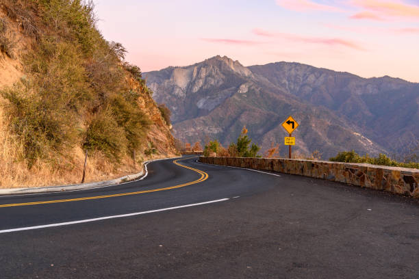 istock Curve on a mountain road at sunset in autumn 1635974681