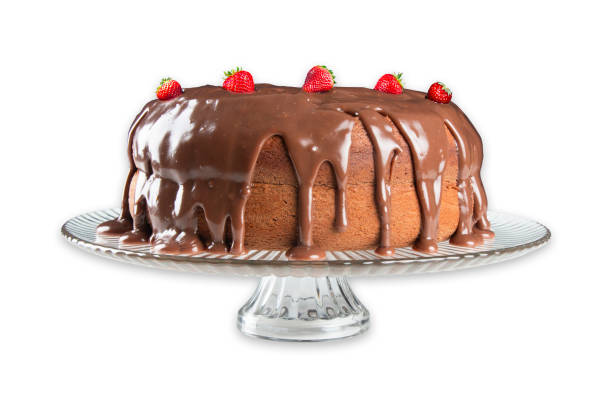 istock Homemade chocolate cake with icing and strawberries. White background 1635991991