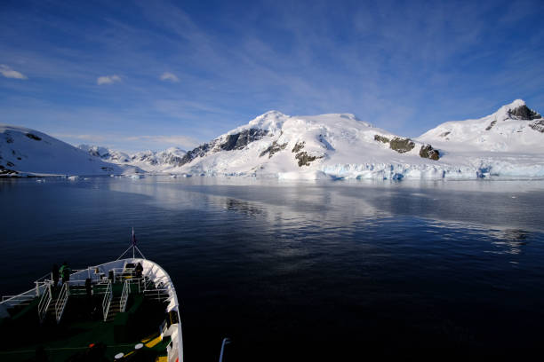 istock Serene Winter Landscape with Mountain Reflection in the Ocean 1635994376