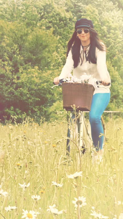 Hippy chic riding a retro style bicycle.