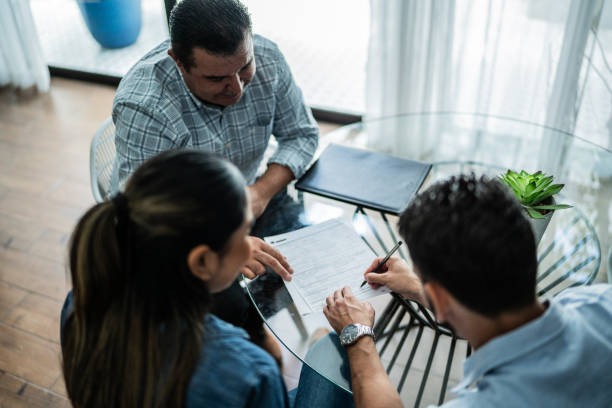 Customers signing contract at a house