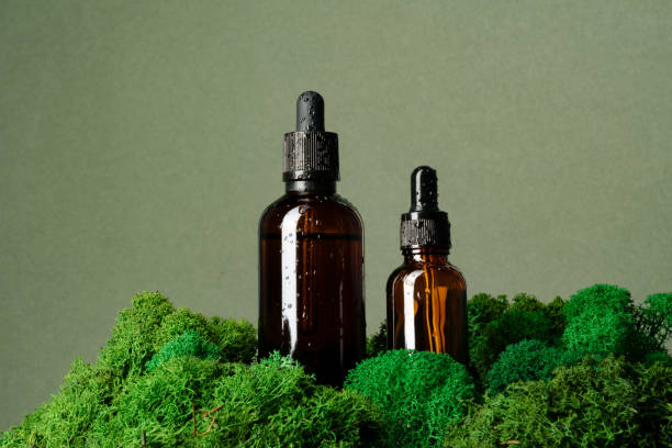 istock Vape smoking liquid bottles on moss background 1636009533