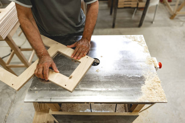 istock Unrecognizable man carpenter making wooden furniture in workshop 1636009989