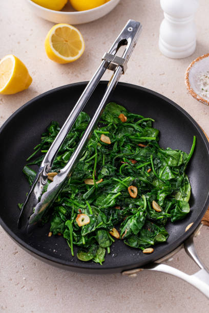 istock Sauteed spinach with garlic in a skillet 1636015968