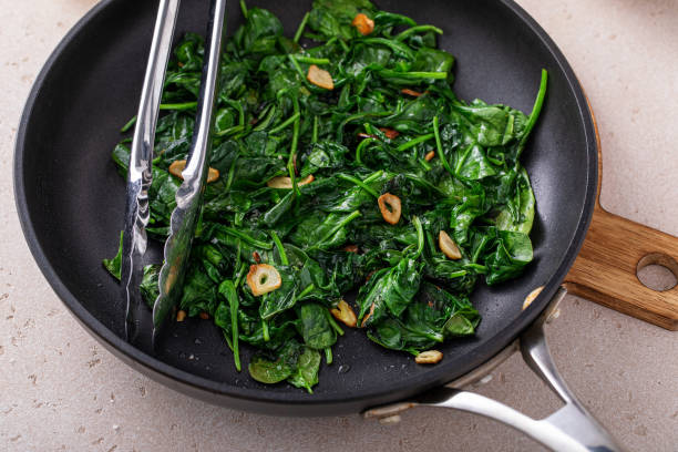 istock Sauteed spinach with garlic in a skillet 1636015970