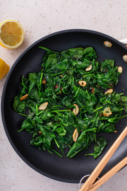 istock Sauteed spinach with garlic in a skillet 1636016443