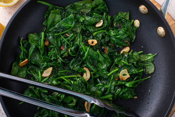 istock Sauteed spinach with garlic in a skillet 1636016476