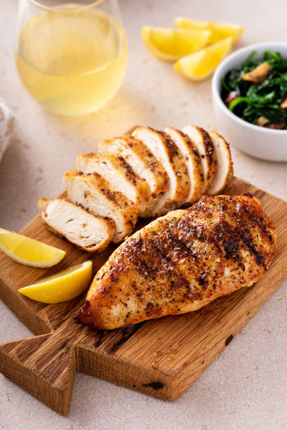 istock Grilled chicken with spice rub and lemon on a cutting board 1636016513