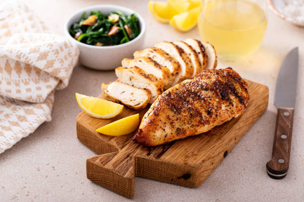 istock Grilled chicken with spice rub and lemon on a cutting board 1636016519