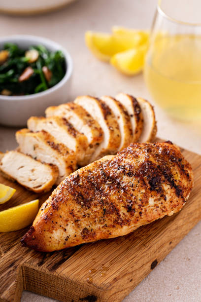 istock Grilled chicken with spice rub and lemon on a cutting board 1636016520