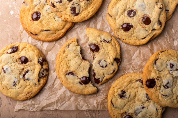 istock Chocolate chip cookies with flaky salt on parchment paper 1636017105