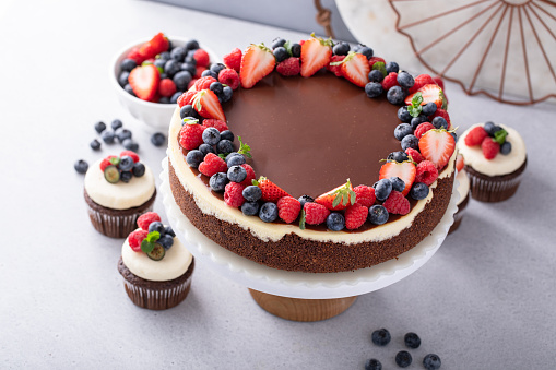Chocolate and vanilla cheesecake topped with dark chocolate ganache and summer berries