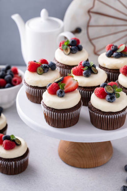 istock Chocolate cupcakes with cream cheese frosting and fresh berries 1636018870