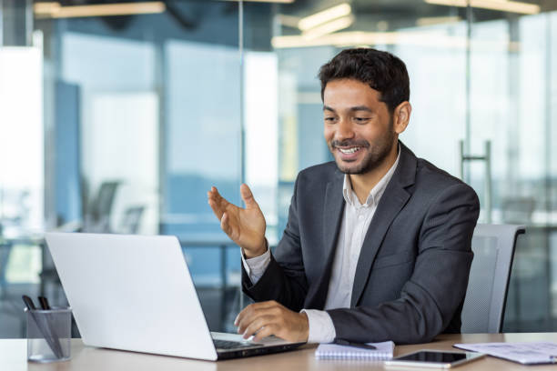 istock Young successful arab businessman inside office at workplace talking remotely with colleagues and partners, man using laptop for video call, satisfied boss smiling and gesturing with hands joyfully 1636024428