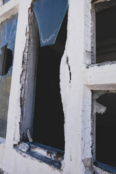 istock Close-up a Broken Glass Pane Window White Frame 1636029142