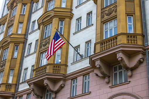 The American flag flies on the wall of the embassy building in the historic building in Moscow