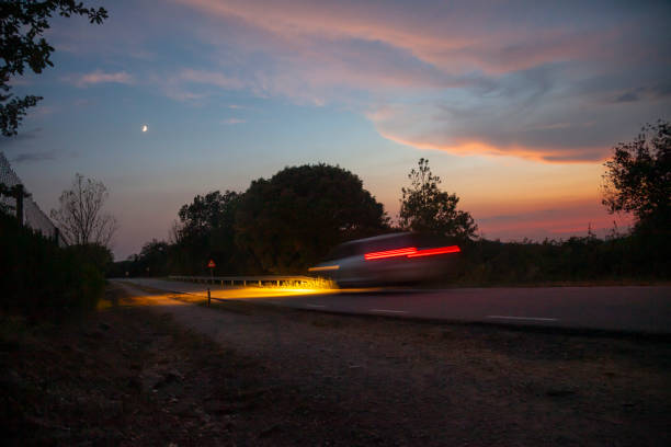 Traveling by car at sunset stock photo