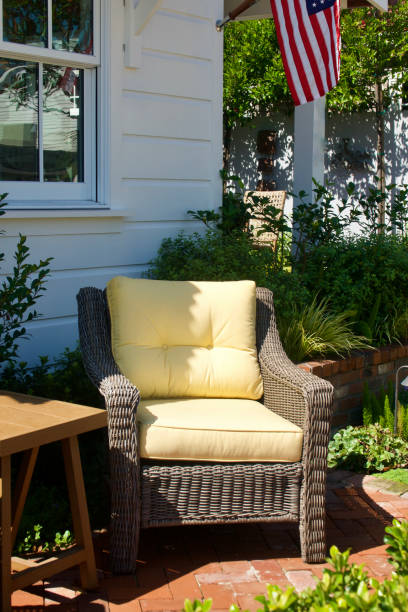 istock Comfortable wicker armchairs on a sunny patio 1636035657