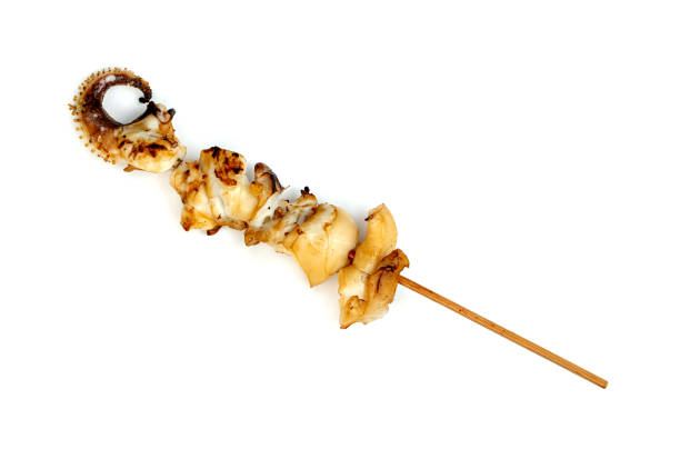 roast tentacles of squid with skewer isolated on white background