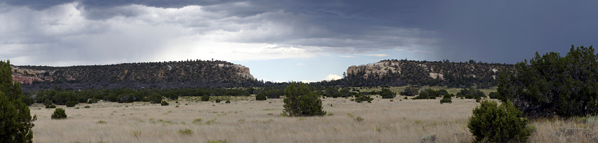 New Mexico Summer rains over Sandstone bluffs.  National Monument since 1906.  Pinon and Juniper Trees.