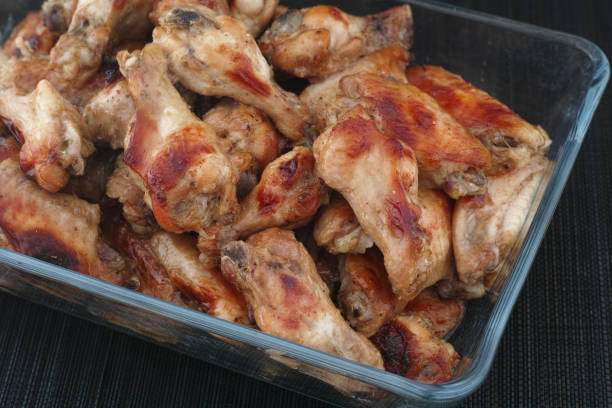 istock Baked chicken wings in a glass container 1636061623