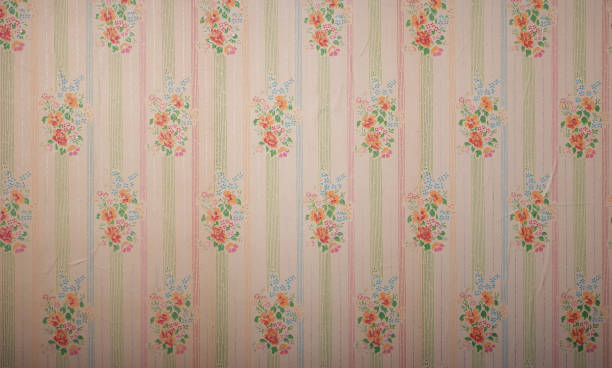 Old wallpaper on the wall. Old wallpaper for texture or background.
