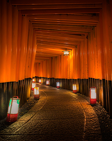 Kyoto, Japan - Oct 10, 2022: Senbon Torii gates illuminated with lanterns at Fushimi Inari Taisha shrine