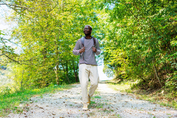 Young black man enjoys the forest walk.