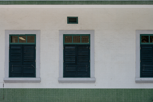 A European style building with white walls and green windows