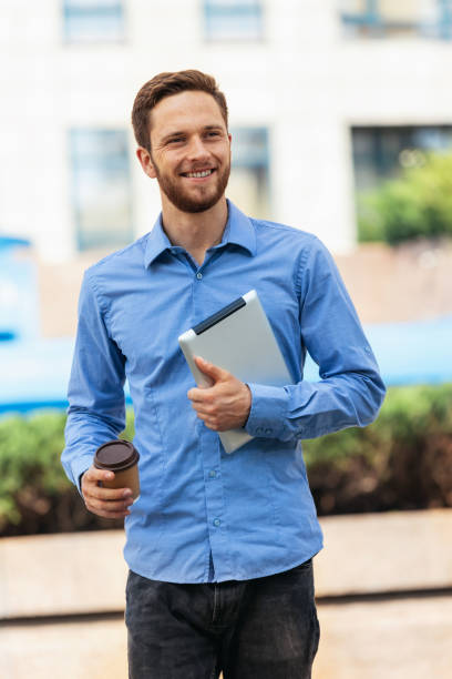 istock Businessman with a tablet and coffee working outdoors 1636086613