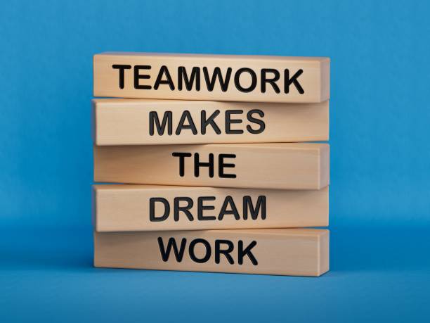 Teamwork makes dream work symbol. Concept words Teamwork makes the dream work on wooden blocks. Businessman hand. Business Teamwork makes dream work concept. Copy space.3D rendering on blue background.
