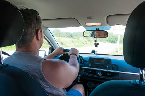 istock Man driving with his hands on the wheel 1636118250