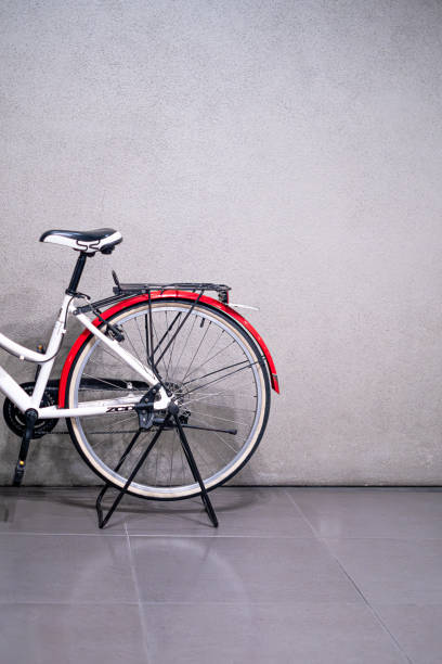 istock Retro old becycle with red and white color front concrete wall background. Vintage old style filtered photo 1636150746