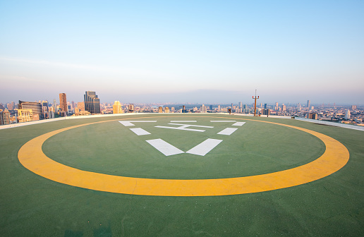 Helipad on the roof of skyscraper with twilight sky scene in the cityscape, Abstract Way, new Start concept