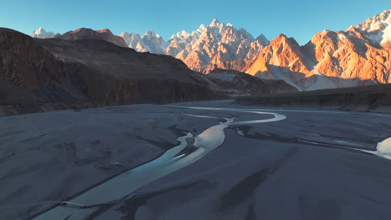 Aerial view sunset scene Passu Mountain Range and hunza river in Karakoram Range in Himalayas mountains along Karakoram Highway in Spring. Northern Pakistan